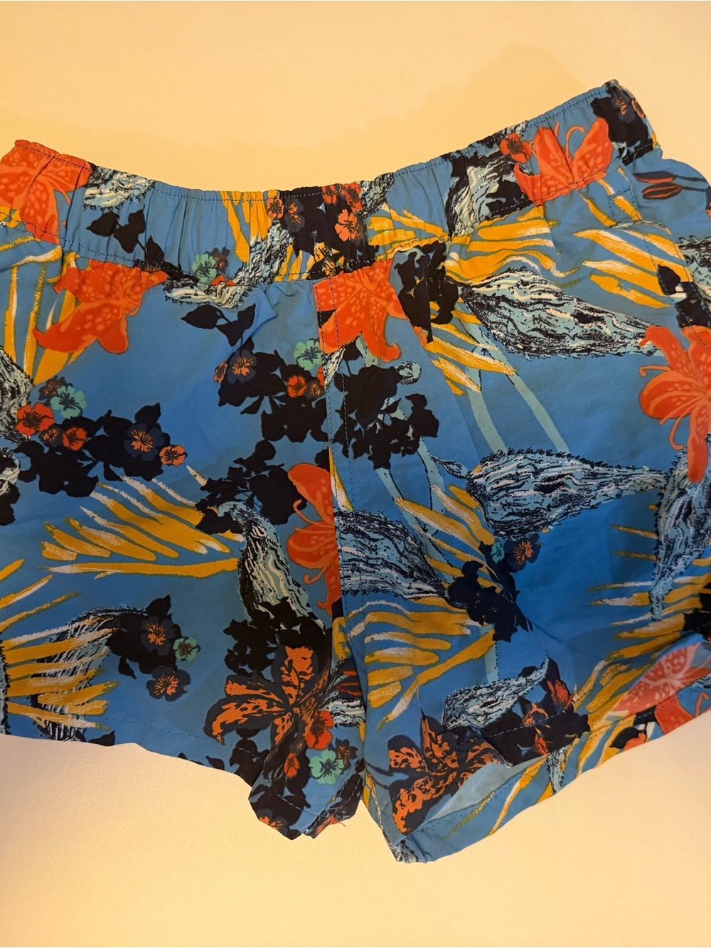 Patagonia Blue Floral Print Athletic Shorts with Orange Accents